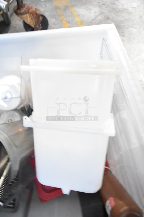 Tiered lot with various items, including white drop-in bins and a beverage dispenser. Items appear used.