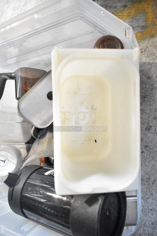 Assorted items including drop-in bins and a beverage dispenser in used condition, showing light wear and minor stains.