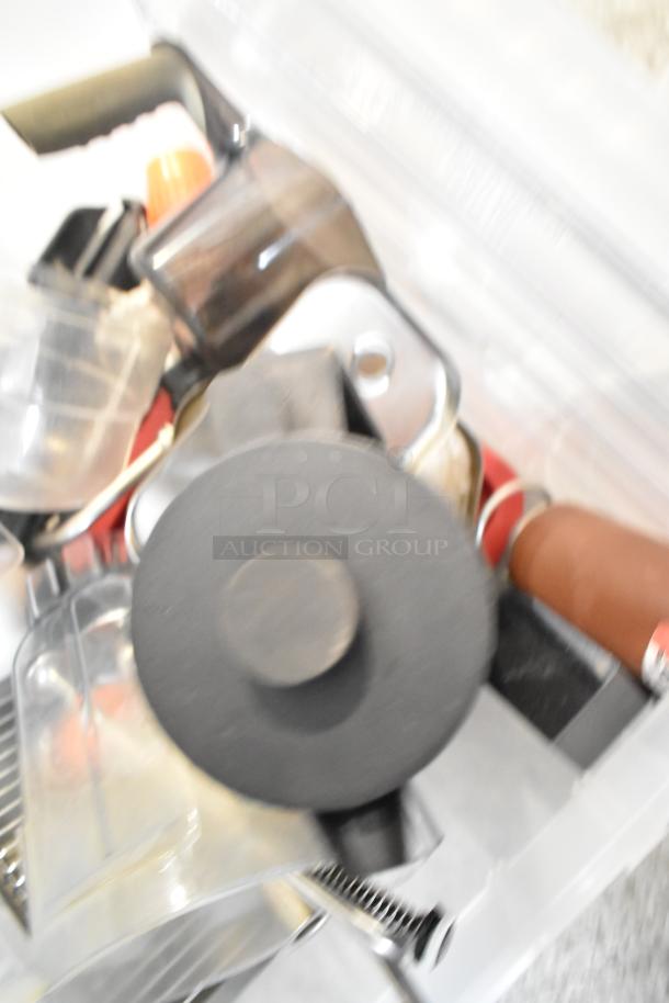 Various kitchen items including drop-in bins and a beverage dispenser in mixed condition, placed in a transparent container.