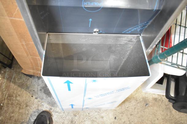 New wall-mount trash can with integrated paper towel dispenser. Minor scratches; protective film partially intact. Ideal for commercial use.