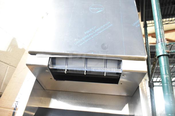 Brand new wall mount trash can with paper towel dispenser, stainless steel, minor scratch and dent, protective film visible.