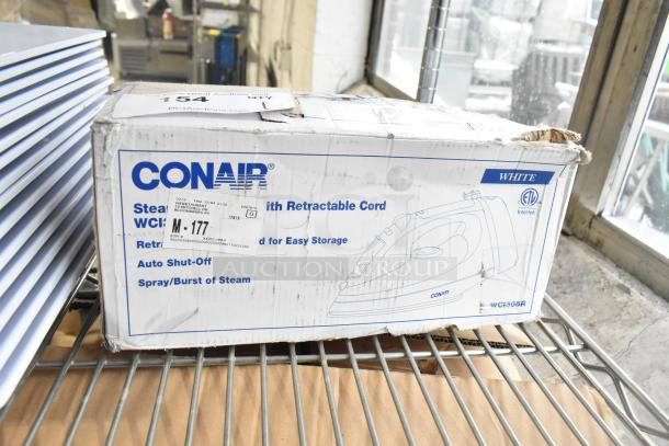 Conair Steam Iron, Model WCH306R, with retractable cord in original packaging. Features auto shut-off, spray/burst of steam. Box slightly worn.