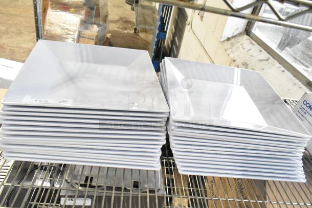 Stack of white square plates on a metal shelf, in good condition. Auction lot includes 31 items like these plates.
