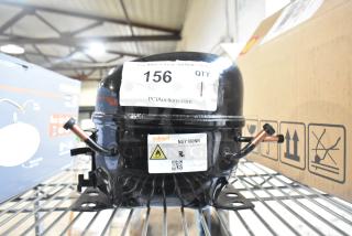 Cubigel NUY100NR motor, 115-127V, 1 phase, black, with label detailing model and voltage on a metal shelf.