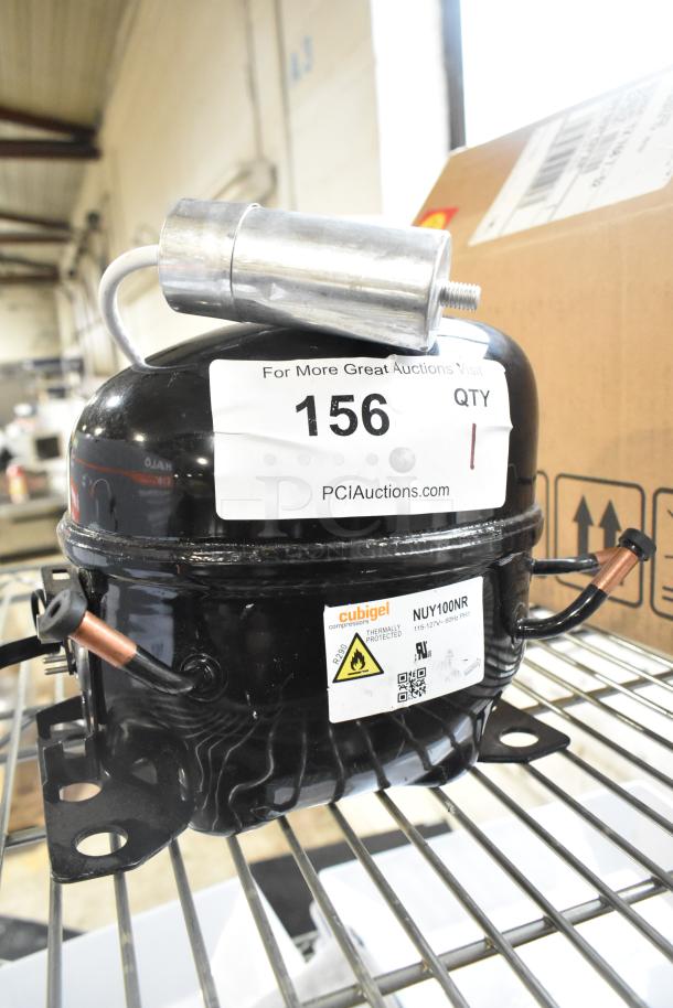 Cubigel NUY100NR Motor, 115-127V, 1 Phase, thermally protected, on shelf. Label features model and power details.