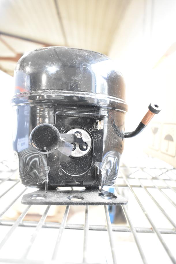 Cubigel NUY100NR motor, black, 115-127 volts, 1 phase, slight wear, metal bracket, visible connectors.