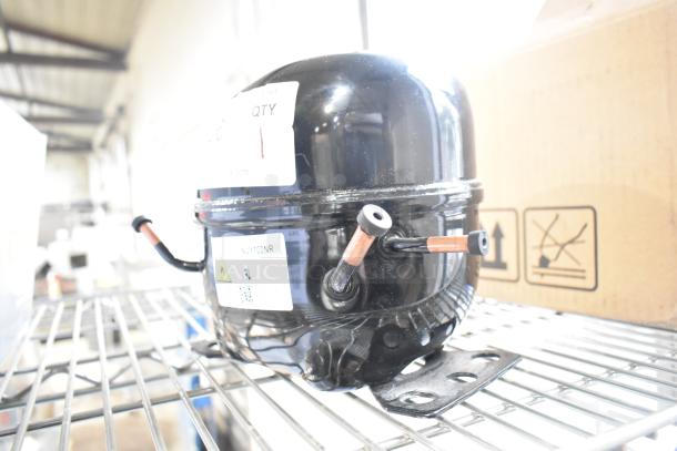 Cubigel NUY100NR motor, black, 115-127 volts, 1 phase, visible label, good condition, on metal rack.