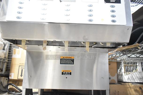 Bunn IMIX-5 commercial cappuccino machine, stainless steel, visible control panel, signs of wear, "HOT LIQUID" warning label.