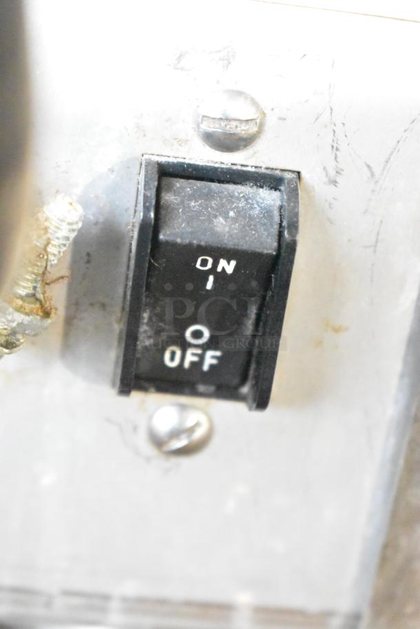 Close-up of a Bunn IMIX-5 switch, showing ON/OFF positions. Part of a commercial cappuccino machine.