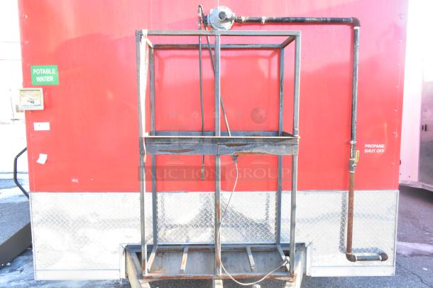 2021 Titanium Cargo 8.5' x 28' mobile kitchen trailer, visible POTABLE WATER and PROPANE SHUT OFF, red exterior.