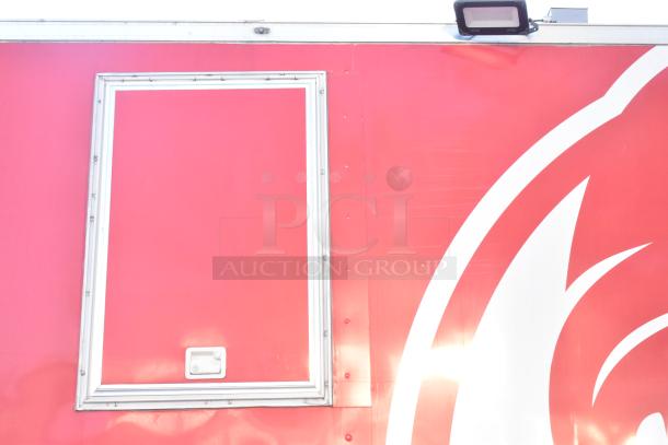 2021 Titanium Cargo 8.5' x 28' mobile kitchen trailer with side access panel, red exterior, previously a Wendy's ghost kitchen.