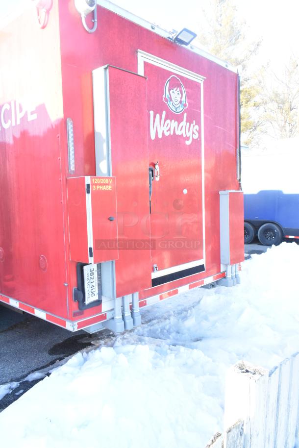 2021 Titanium Cargo 8.5' x 28' red mobile kitchen trailer with CaptiveAire grease hood, Wendy's branding, and 120/208V 3-phase electric.