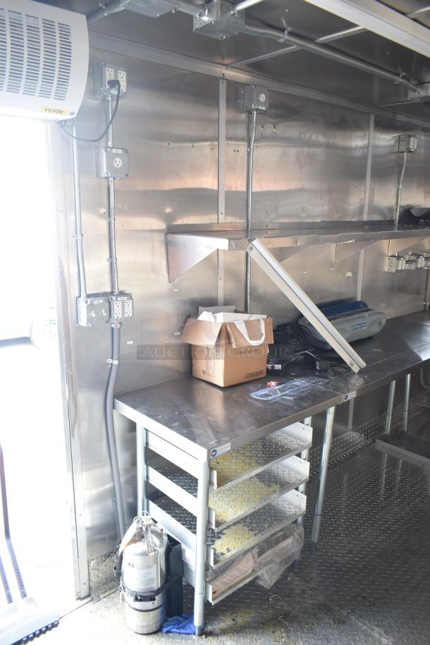 2021 Titanium Cargo mobile kitchen trailer interior showing stainless steel workspace, electrical outlets, and shelving.