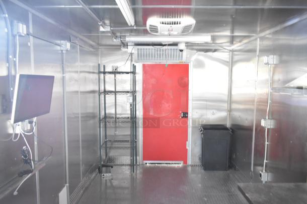 2021 Titanium Cargo 8.5' x 28' mobile kitchen trailer interior, featuring a CaptiveAire grease hood, plumbing, and electric setup.