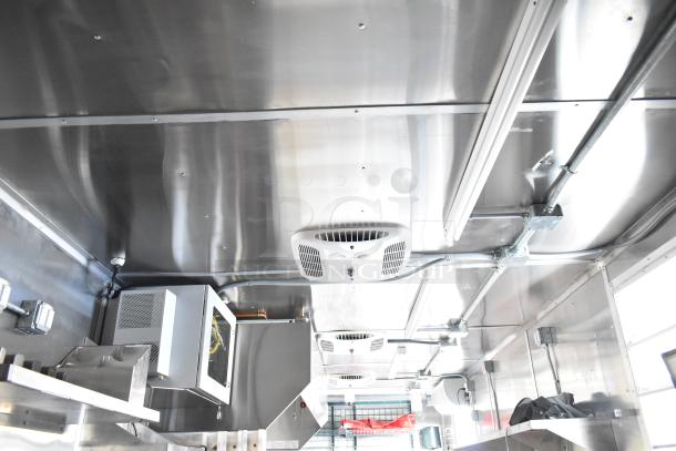 2021 Titanium Cargo 8.5' x 28' Mobile Kitchen interior with 7'7" CaptiveAire grease hood, 3-phase electric, and plumbing setup.