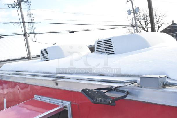 2021 Titanium Cargo 8.5' x 28' mobile kitchen trailer roof with snow, air conditioning units visible.