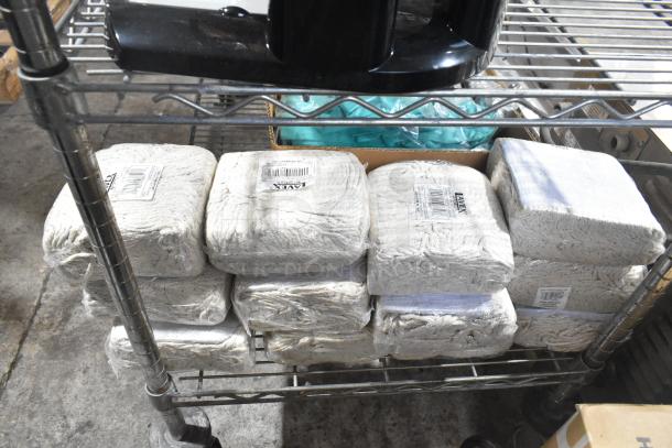 13 brand new Lavex 24 oz. #32 natural cotton wet mop heads, each with 5" headband, packed on metal shelf.