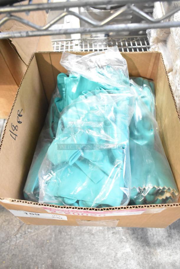 Cardboard box containing new teal latex gloves in plastic bags, labeled "48 PR." Items are in scratch and dent condition.