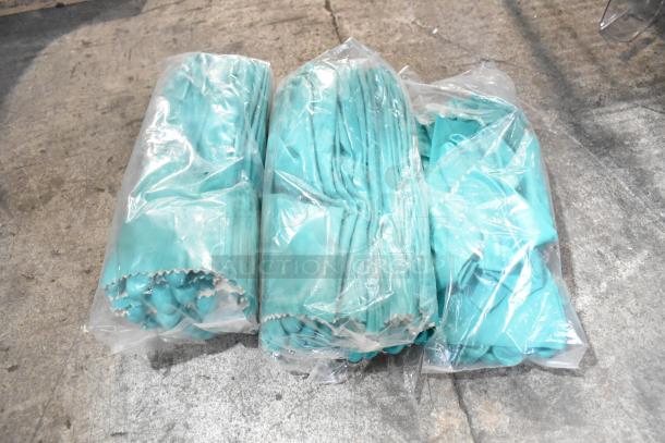 Brand new unopened packs of turquoise gloves, three sets, packaged in clear plastic bags.
