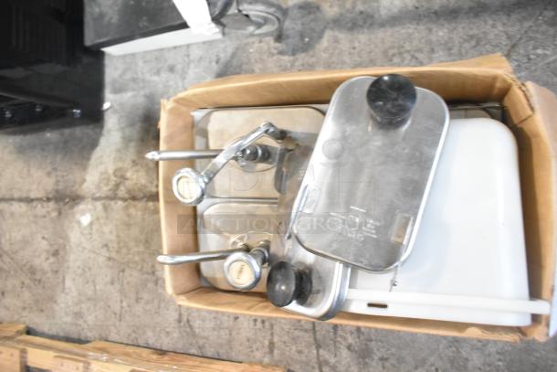 Cardboard box containing metal topping dispensers and other items. Items show moderate wear, suitable for catering use.