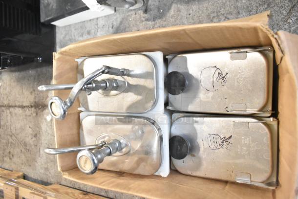 Box of metal topping dispensers with pumps and hand-drawn fruit designs. Appears gently used with visible markings.