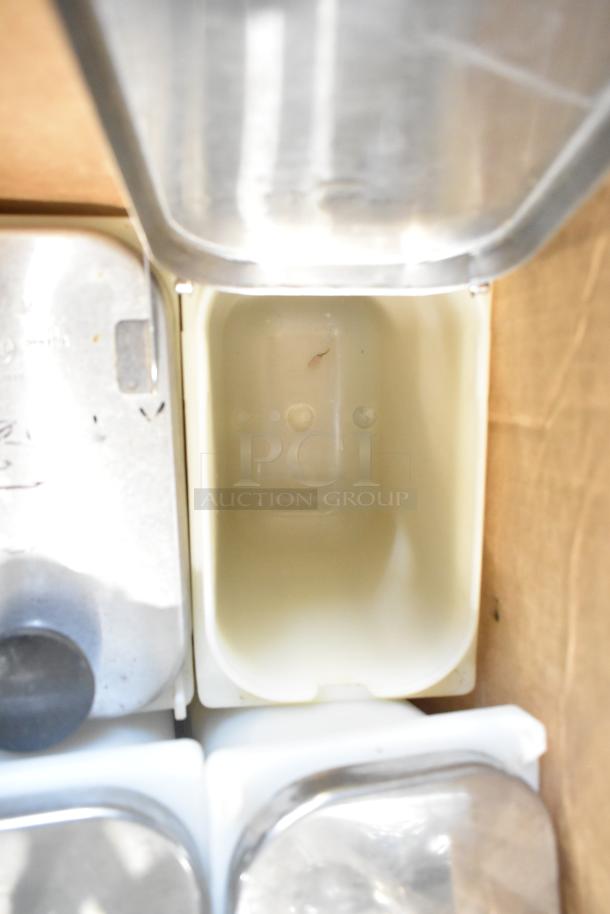 Five various items, including Reserve 9324 Prism wine glasses and topping dispensers, shown in storage. Some have metal lids.