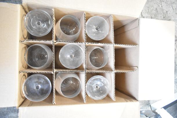 Box containing multiple Reserve 9324 Prism wine glasses, separated by cardboard dividers, showing slight wear signs.