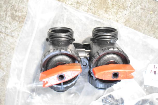 Plastic fittings with red valves, marked for off/on, packaged in a clear bag. Condition appears new.