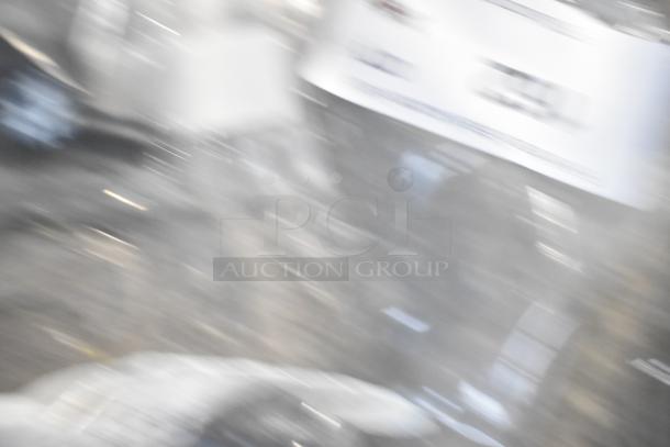 Blurry image showing assorted items including a start relay, plastic fitting, and parts bag. Specific details unclear.