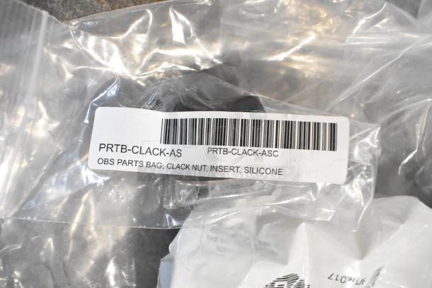 Clear plastic bag labeled "PRTB-CLACK-AS" containing a clack nut, insert, and silicone parts.