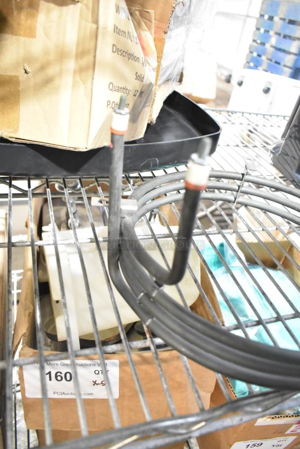 Four various electrical and mechanical items on a metal shelf, including wires and a cardboard box labeled "160 QT."