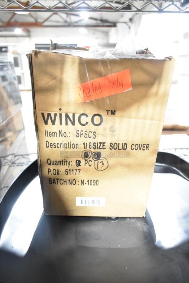 Cardboard box labeled "Winco SPSCS 1/6 Size Solid Cover," containing steam pan lids. Quantity noted as 13.