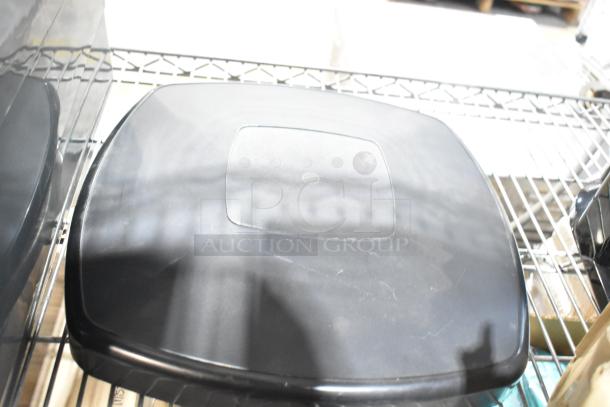 Alt text: Gray Slim Jim trash can lid on a metal shelf, part of a 6-item auction lot including Winco steam pan lids.