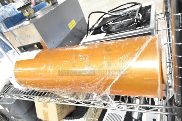 Roll of 500mm RMF-1M plastic wrap on a shelf, new condition, transparent orange, with label indicating product details.