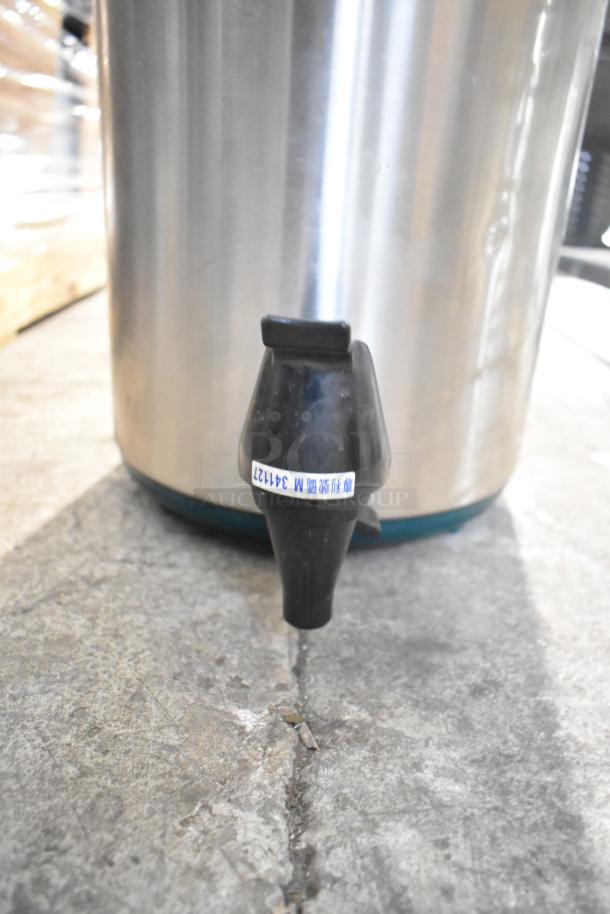 Stainless steel YM-1007 Beverage Dispenser, spigot visible, minor scuffs, tag with markings "341122".