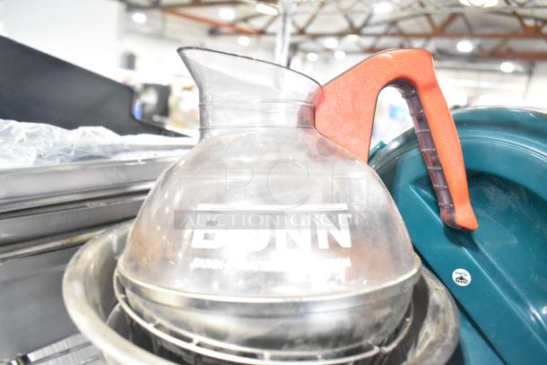 Bunn coffee decanter with red handle, minor wear. Part of 10 items, including stainless steel bins and brew basket.