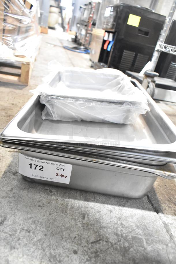 Stainless steel drop-in bins stack with protective packaging; labeled "172, PCI Auctions." Includes 10 varied items.