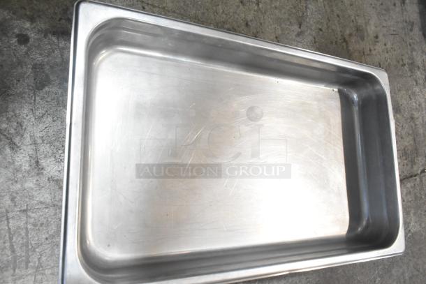 Stainless steel drop-in bin, rectangular shape, visible light scratches, suitable for various uses.