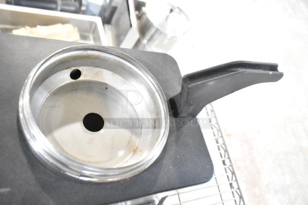 Server FSPW-SS 81140 Supreme 3 Qt. Hot Topping Warmer with Pump, 120V, stainless steel, used, close-up of interior.