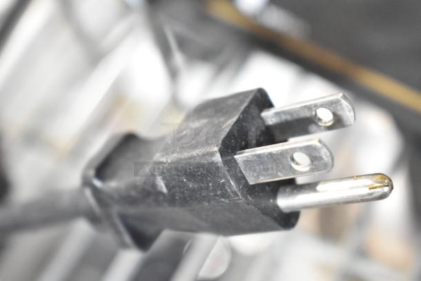 Close-up of a three-prong plug, part of the Server FSPW-SS 81140 Hot Topping Warmer. Appears in used condition.