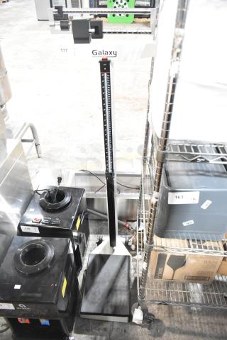 Galaxy floor style scale with height measure, black and white finish, good condition. Marked with "Galaxy" branding.