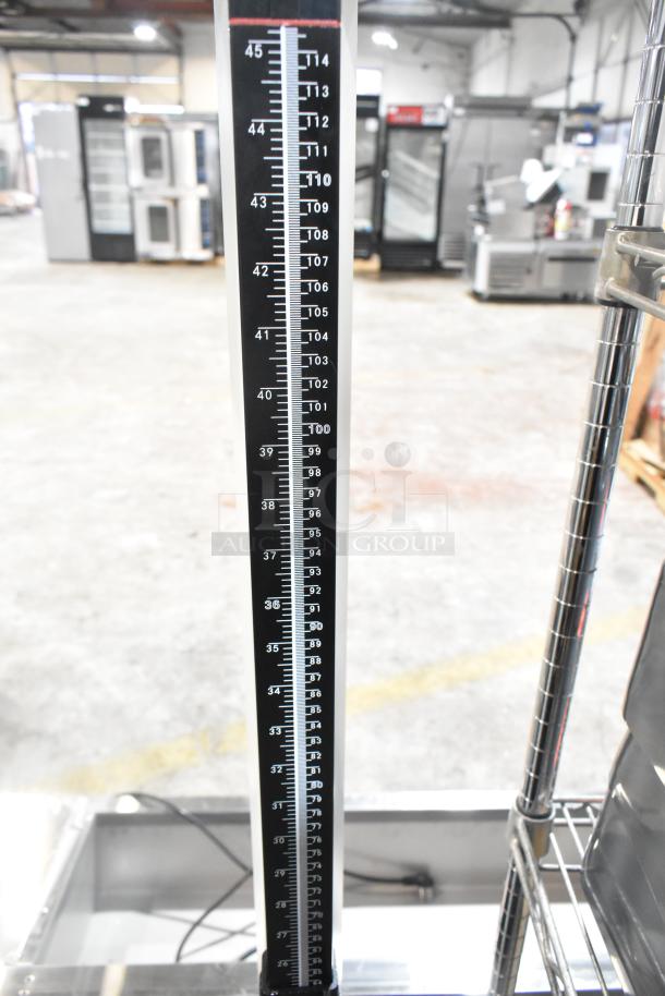 Galaxy floor scale, black and white measuring column with detailed numerical markings, used condition.