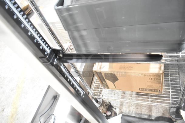 Galaxy Floor Style Scale with dual measurement bars, black and white markings, in excellent condition on a metal rack.