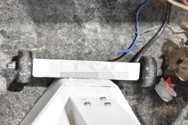 Galaxy Floor Style Scale with white frame, visible wheels, and wiring. Signs of use; suitable for industrial settings.