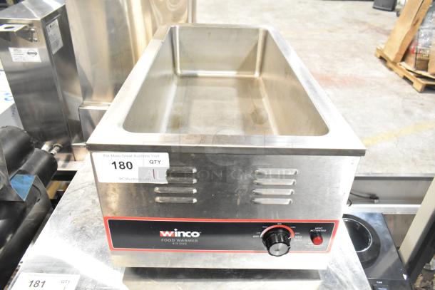 Winco FW-L600 countertop food warmer, 120 volts, 1 phase, stainless steel, visible control knob, minor wear on surface.