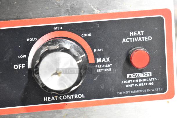 Winco FW-L600 countertop food warmer control panel, showing heat settings from low to max and caution indicators.