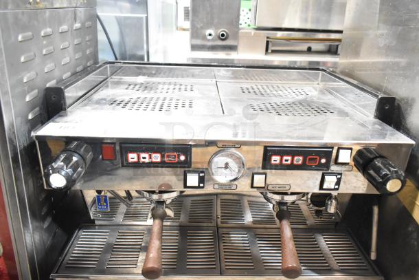La Marzocco 2-group espresso machine with 2 portafilters, steam wands, and pressure gauge. Stainless steel, good condition.