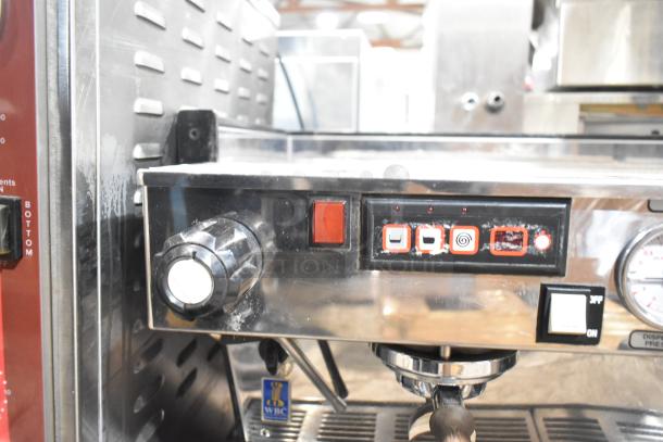 La Marzocco commercial 2 group espresso machine, includes 2 portafilters, steam wands, gauges; some wear visible.