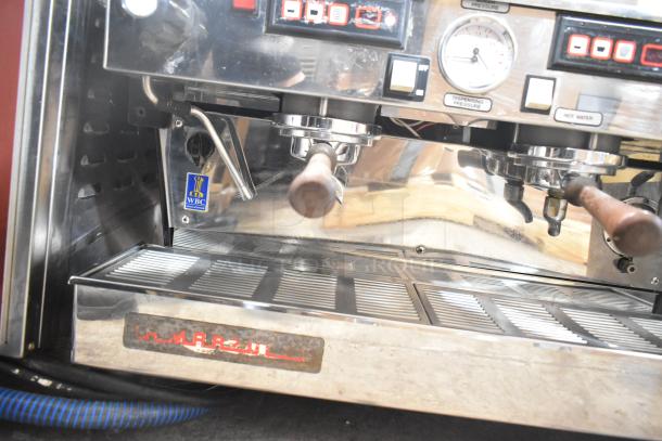 La Marzocco 2 Group Espresso Machine, stainless steel, with 2 portafilters and steam wands. WBC sticker visible.
