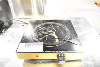 Countertop single burner induction range with decorative design, visible cooktop crack, model number 187.